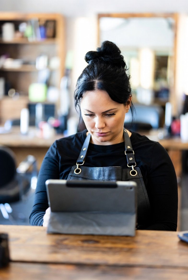 Female cosmetologist at salon desk