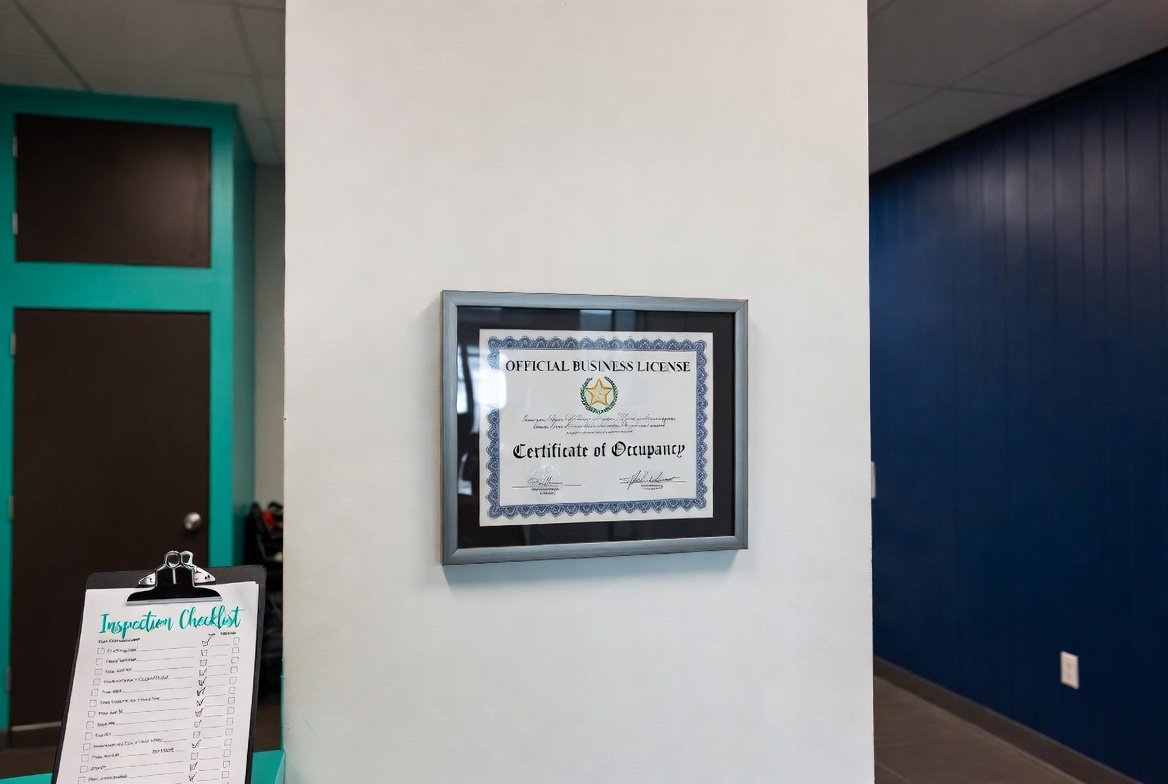 Framed TDLR cosmetology salon license on salon wall beside an inspection checklist